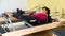 Sporty adult Latina doing stretching exercises on pilates reformer