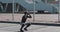 Sporty African American man doing squats outdoors near the sports stadium. Workout, fitness, health, beauty, motivation