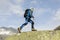 A sporty alpinist climbs a mountain summit in the Swiss Alps