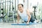 Sporty Asian Senior man in white shirt push up while exercising at the gym. Happy smiling Healthy Old male stretching after a