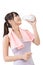 Sporty asian woman drinking water from a bottle