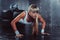 Sporty athlete woman doing push ups on tire