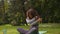 Sporty athletic Caucasian woman girl sport female on fitness mat in park outdoors yoga pilates stretching workout body