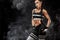 Sporty beautiful afro-american model, woman in sportwear makes fitness exercising at black background to stay fit