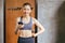 Sporty beautiful asian woman posture standing and holding mobile phone and exercises muscle at gym,Happy and smiling