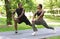 Sporty Black Couple Preparing For Marathon Together, Stretching Muscles Before Jogging Outdoors