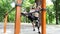 Sporty blonde girl and man is warming up before training in a park outdoor.