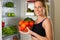 Sporty, Caucasian woman showing vegetables for healthy eating