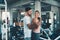 Sporty couple exercising dumbbell weights lifting in fitness gym., Portrait of attractive young couple are practicing workout in