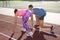 Sporty couple ready for running at stadium