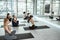 Sporty diverse female group practice yoga indoors