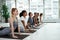 Sporty diverse women practice yoga at group class