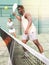 Sporty emotional man playing doubles paddle tennis