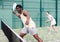 Sporty emotional man playing doubles padel game