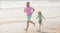 sporty family of daddy man and child boy running on beach together, summer