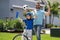 Sporty family. Excited father and son with winning gesture. Father and son in bike helmet learning ride bicycle. Father