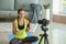 Sporty female blogger with bottle of vitamins recording video at home