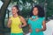 Sporty female friends training together. Cute black woman and pr