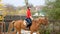 Sporty female jockey practices riding.