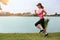 Sporty female jogger morning exercise on seaside on grass. vintage tone