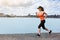 Sporty female jogger morning exercise on seaside on grass. vintage tone