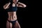 Sporty female with perfect body against black background. Fitness woman in sportswear with ideal fitness body.