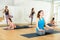 Sporty females doing stretching workout during group training