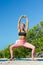 Sporty fit middle aged woman doing  yoga,   working out and training on the tropical beach. Female yoga instructor. Solo outdoor a