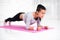 Sporty fit sliming girl doing plank exercise in