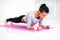 Sporty fit sliming girl doing plank exercise in yoga class. fitness, home and diet concept.