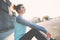 Sporty and fit woman sitting on the street, resting after nice workout. Urban sport