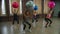 Sporty fit women doing squat with fitness ball indoors