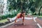 Sporty fit young woman doing handstand exercise in firefly postu