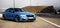 Sporty German bmw m3 sedan on a winding mountain road.