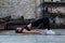 Sporty girl doing floor hip raise or lift exercise lying on floor in her loft apartment