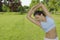 Sporty girl exercising on meadow against the sky