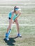 Sporty girl holding hockey stick standing ready to hit hockey ball