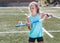Sporty girl hopping a hockey ball on her hockey stick.