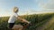 Sporty girl riding bicycle between sunflower fields