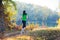 Sporty girl running on the pathway in the forest