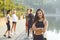 Sporty girl smiles on the background of friends athletes in the park