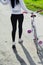 Sporty girl walks with a bicycle. plan back. Pretty fitness girl with sport bike walks in the park. Portrait of a young fitness