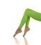 Sporty green leggings on slim pretty bare legs on a white background. Side view