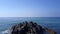 Sporty lady silhouette in yoga pose on grey rocky cliff