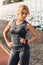 Sporty Lifestyle. Young woman standing on stadium looking down at watch serious