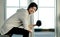 Sporty look Asian woman lifting dumbbells and smiling in gym