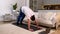 Sporty male doing pike push up exercise practicing on yoga mat at home