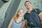 Sporty male and female posing at climbing wall