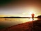 Sporty Man doing Morning Jogging on Sea Beach at Bright Sunrise Silhouettes