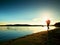 Sporty Man doing Morning Jogging on Sea Beach at Bright Sunrise Silhouettes